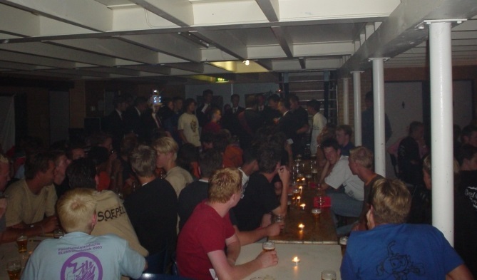 A picture of freshmen attending the cantus during the introduction camp of 2003, shirts of SoepEL and SnorkEL can be seen.